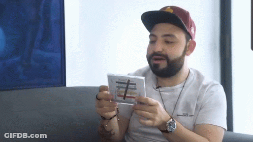 Bearded Man With Hat And Watch Holding CD GIF