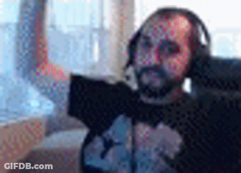 Bearded Man With Headphones And Microphone At Laptop GIF