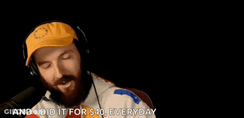Bearded Man With Headphones And Yellow Hat Talking Into Microphone GIF