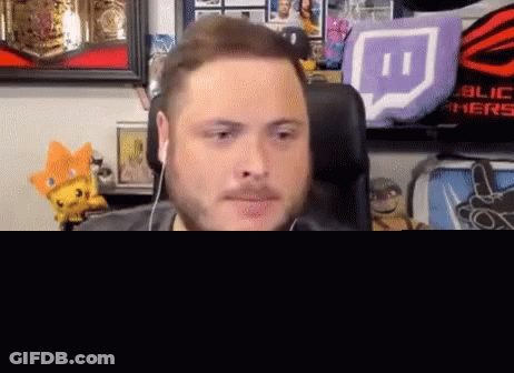 Bearded Man With Headphones Sitting In Front Of Stuffed Animals GIF
