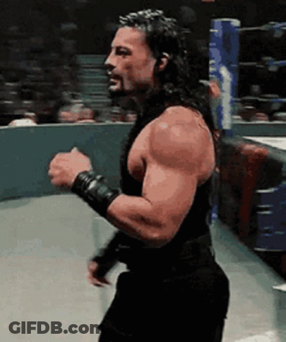 Bearded Man With Long Hair Fist In Air In Ring GIF