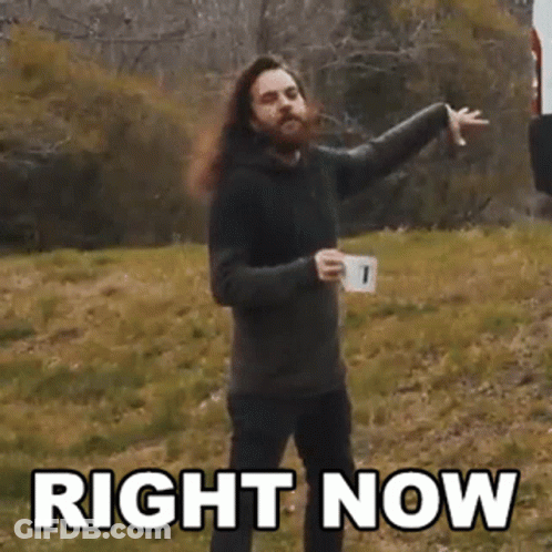 Bearded Man With Long Hair Holding Coffee And Pointing GIF