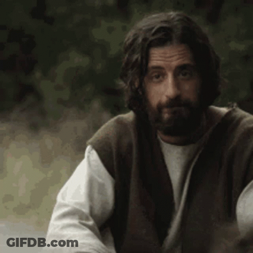 Bearded Man With Long Hair In Vest And White Shirt GIF