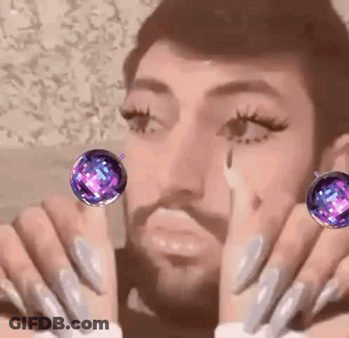 Bearded Man With Long Nails And Earrings GIF