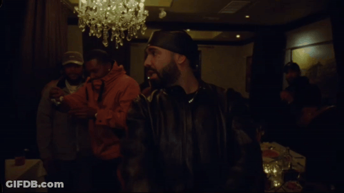 Bearded Man With Necklace In Dark Room GIF