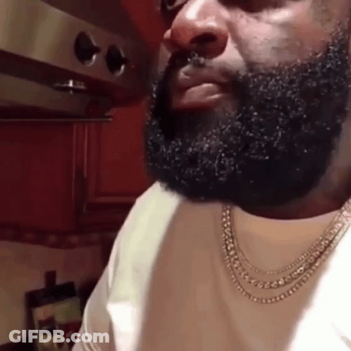 Bearded Man With Necklace In Kitchen GIF