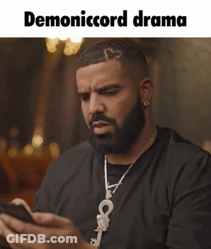 Bearded Man With Necklace Looking At Phone Demonicord Drama GIF
