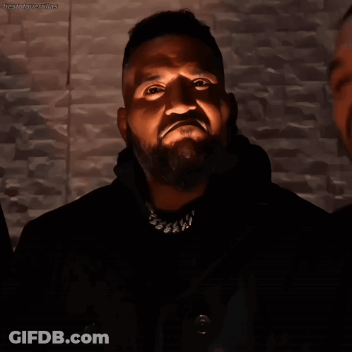Bearded Man With Necklace Looking Up At Light GIF