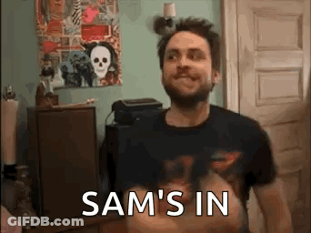 Bearded Man With Sam's In On Shirt GIF