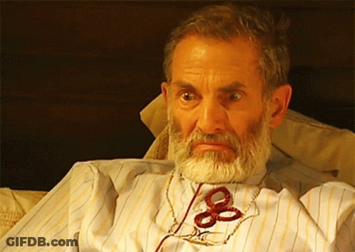Bearded Man With Scissors Tied To Neck GIF