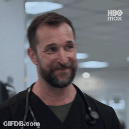 Bearded Man With Stethoscope Smiling In Front Of HBO Max Screen GIF
