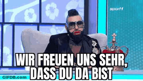 Bearded Man With Sunglasses And Crown Sitting On Chair GIF