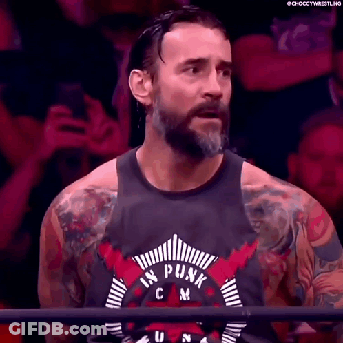 Bearded Man With Tattoos In Punk Tank Top GIF