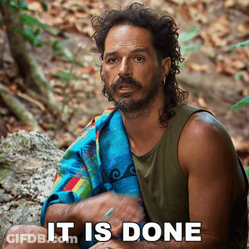 Bearded Man With Towel Sitting On Rock Says It Is Done GIF