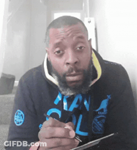 Bearded Man Writing On Paper In Kangol Hoodie GIF