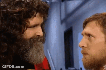 Bearded Men Stare At Each Other In Dark Room GIF