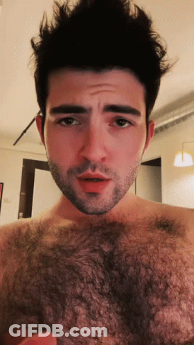 Bearded Shirtless Man Looking At Camera GIF