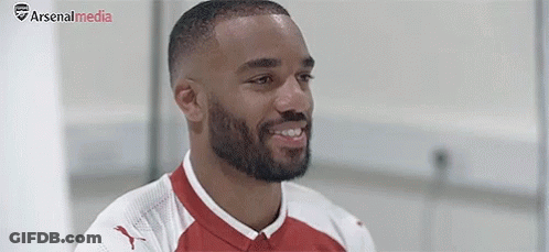 Bearded Soccer Player Smiling In Red And White Jersey GIF