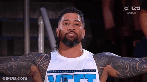 Bearded Tattooed Man In White Tank Top Saying VCT GIF
