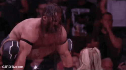Bearded Wrestler Kneeling Next To Woman In Match GIF