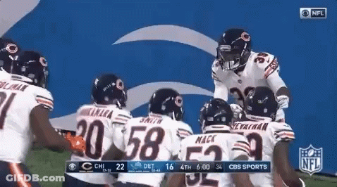 Bears Players Huddled On Field GIF