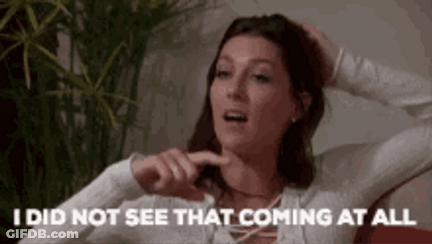 Beautiful Woman Sitting Pretends To Be Shocked GIF