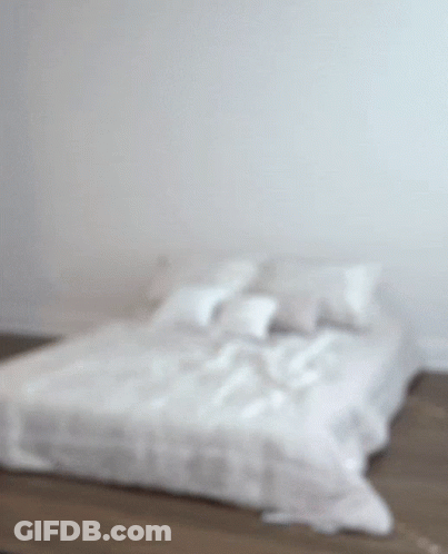 Bed With White Sheets And Pillows GIF