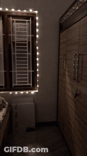 Bedroom With Bed And Window Blinds GIF