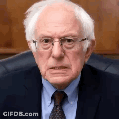 Bernie Sanders Is Wearing Glasses And A Suit And Tie And Making A Funny Face . GIF