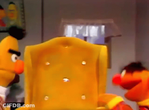 Bert And Elmo From Sesame Street Are Sitting In A Chair GIF
