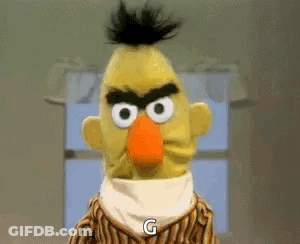Bert From Sesame Street Is Angry And Says `` G '' While Standing In Front Of A Window . GIF