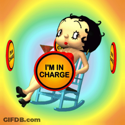 Betty Boop Is Sitting In A Rocking Chair With A Sign That Says " I 'M In Charge " GIF