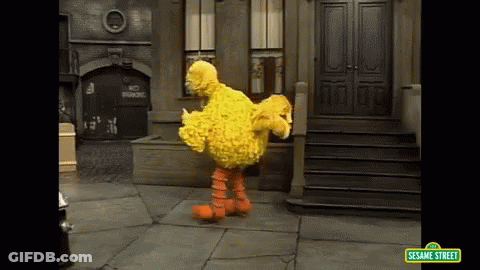 Big Bird From Sesame Street Is Dancing On A Sidewalk GIF