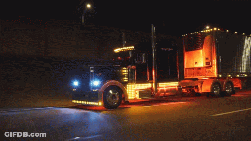 Big Rig Truck Driving Down Road At Night GIF
