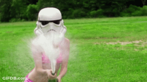 Bikini Woman With Storm Trooper Helmet And Water Gun GIF