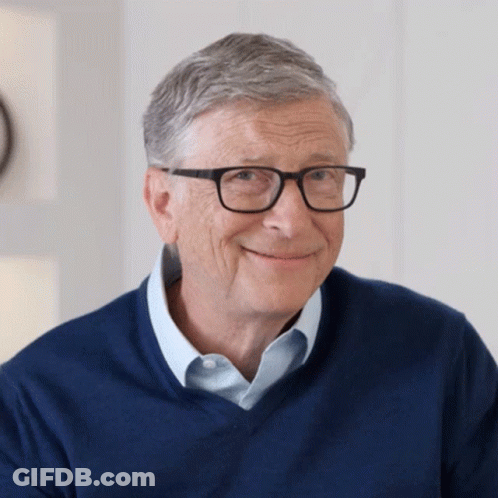 Bill Gates Smiling In Glasses And Blue Shirt GIF
