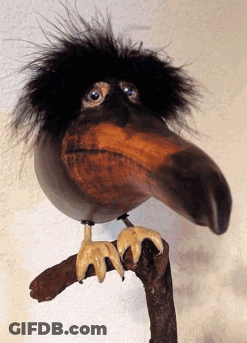 Bird Statue With Long Beak On Branch GIF