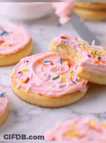 Bitten Cookie With Pink Frosting And Sprinkles GIF