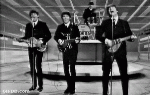 Black And White Beatles Performing On Stage GIF