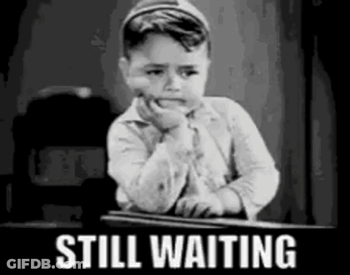 Black And White Boy Sitting At Desk Still Waiting GIF