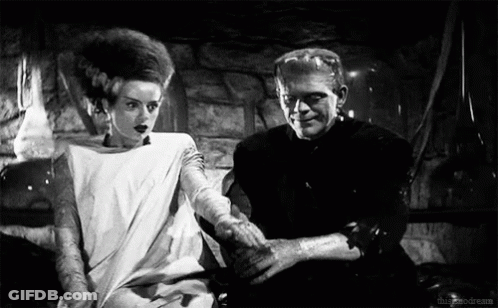 Black And White Bride And Groom Sitting Together GIF