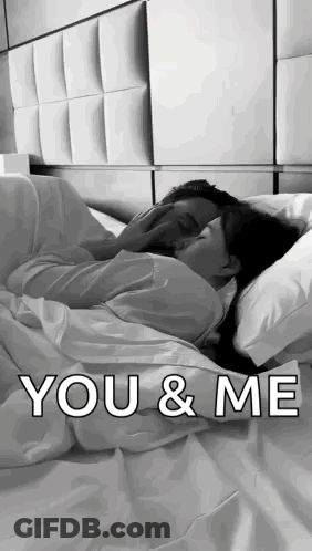 Black And White Couple Hugging In Bed GIF