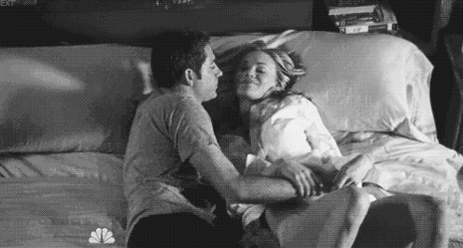 Black And White Couple On Bed Snuggles GIF
