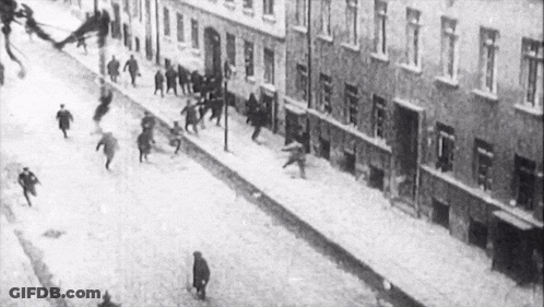 Black And White Crowd Running Down Street GIF