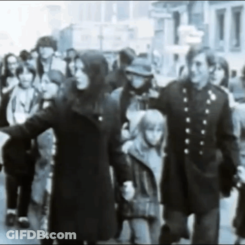 Black And White Crowd Walking Down Street GIF