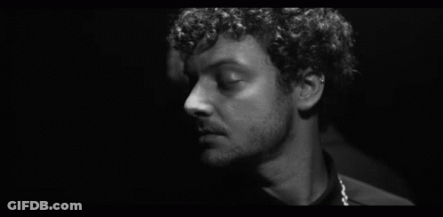 Black And White Curly Haired Man Looking At Another GIF