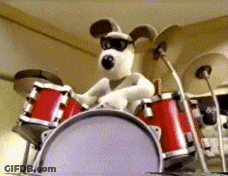 Black And White Dog Playing Drum GIF