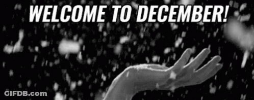 Black And White Hand Reaching In Snow Saying Welcome To December GIF