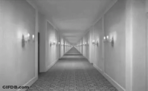 Black And White Hotel Hallway With Door GIF