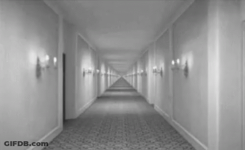 Black And White Hotel Hallway With Door GIF